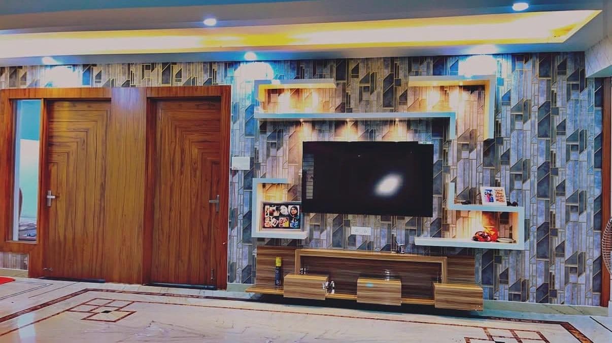 Living room TV wall interior by Ishan Developers